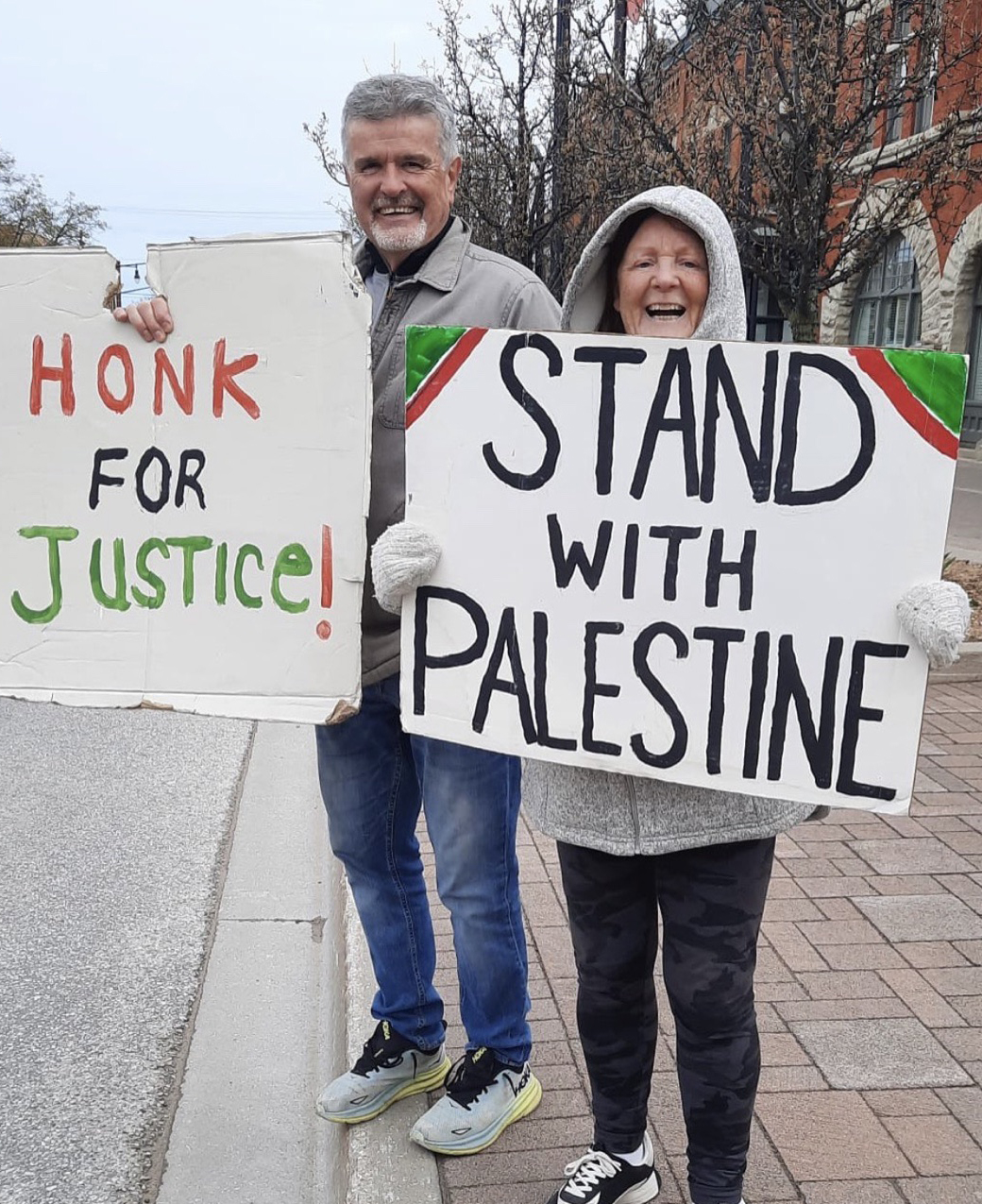 Community members in Collingwood holding signs in support of Palestine